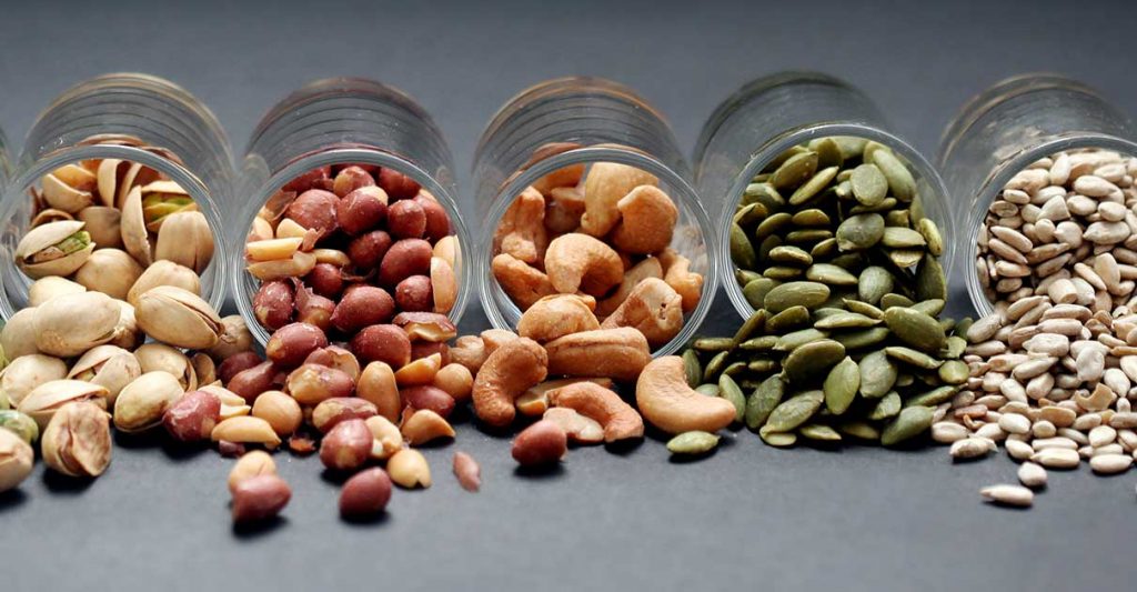 A colorful assortment of nutrient-dense Superfoods for Optimal Health, including berries, dark leafy greens, nuts, and seeds, displayed on a rustic wooden table.