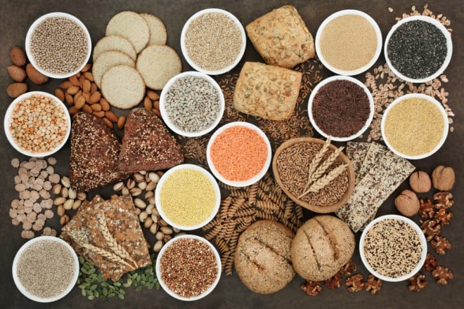 A colorful assortment of nutrient-dense Superfoods for Optimal Health, including berries, dark leafy greens, nuts, and seeds, displayed on a rustic wooden table.